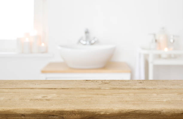 istock Table board before heavily blurred spa salon bathroom shelves background 1308291882