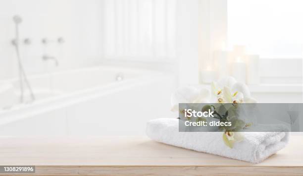 Towel And Orchid Flowers On Wooden Table With Copy Space Stock Photo - Download Image Now