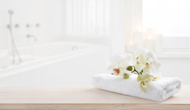 towel and orchid flowers on wooden table with copy space - beauty spa spa treatment health spa orchid imagens e fotografias de stock