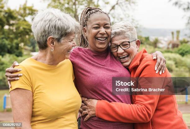 Happy Multiracial Senior Women Having Fun Together Outdoor Elderly Generation People Hugging Each Other At Park Stock Photo - Download Image Now