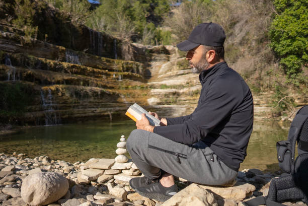 istock Man reading book outdoor vacations Lifestyle. 1308292626