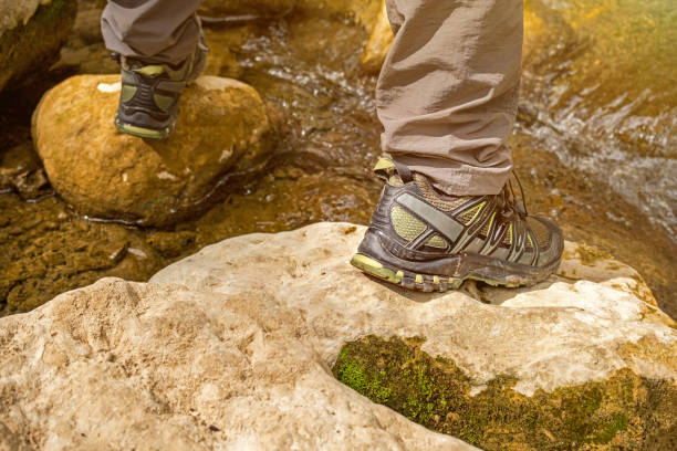 istock Walking shoes close up at the stream crossing 1308293341