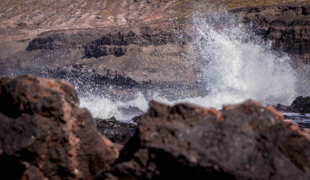 istock Waves Breaking Against A Rocky Beach 1308294619