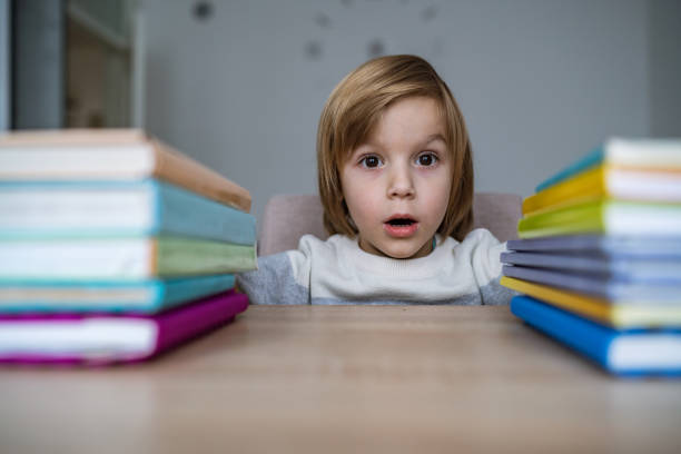 istock Little boy with books at home 1308294735