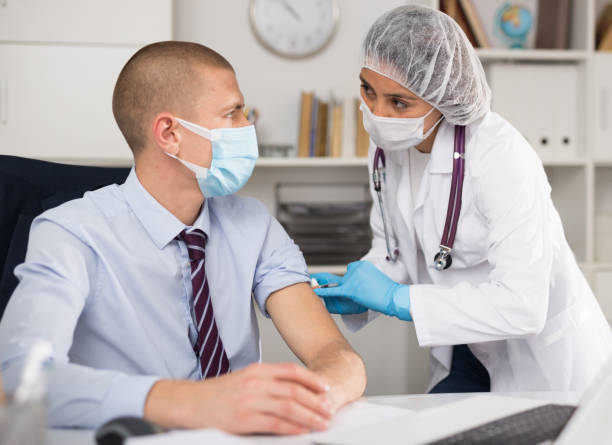 istock Vaccination of an office worker in company office 1308294966