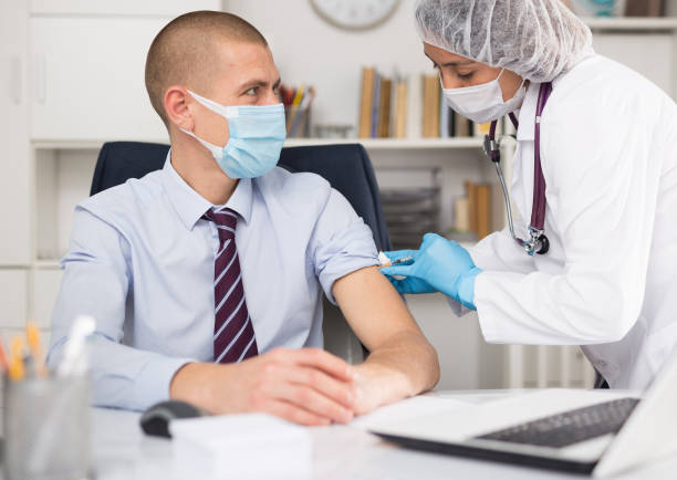 istock Vaccination of an office worker in company office 1308294968