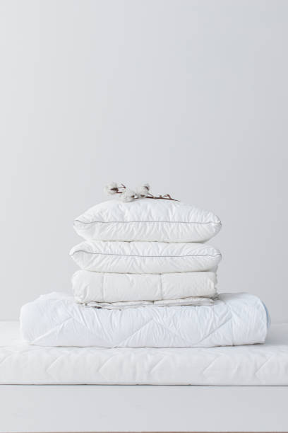 istock Fluffy White Cotton Pillows and a Duvet on a Mattress (Copy Space) 1308295178