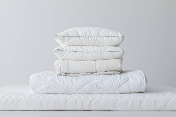 Soft Cotton Pillows and a Duvet on a White Mattress