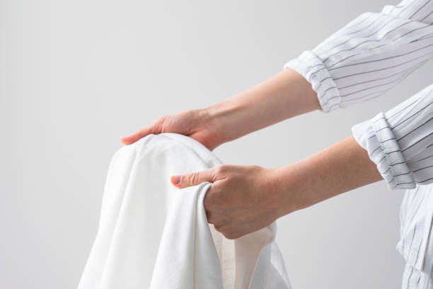 istock Hotel Worker Holding a Clean Bed Sheet 1308295195