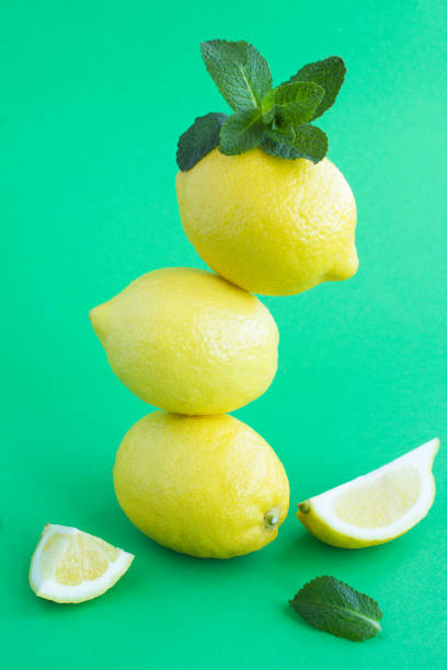 istock Lemons stacked pyramid on the green background 1308295271
