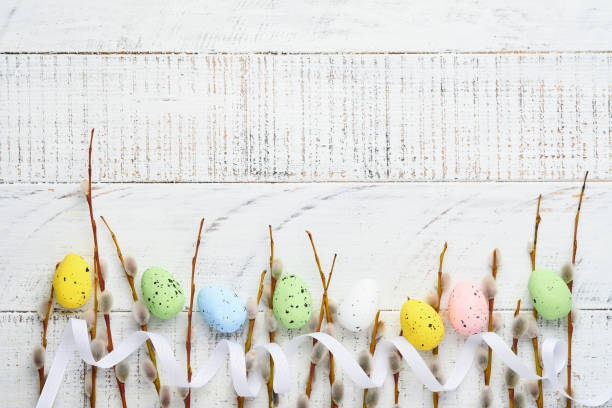 istock Pussy willows branches and Colorful easter gingerbread rabbit, eggs and chickens on white old wooden background. Festive Easter concept with copy space. Flat lay 1308295401