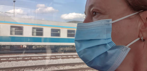 istock Mature women with protective face mask in train 1308296221