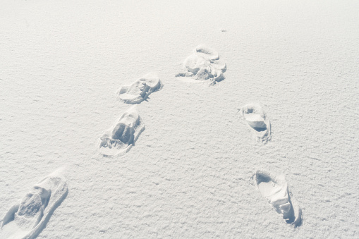 Line of footprints in frozen deep snow, Slovenia.