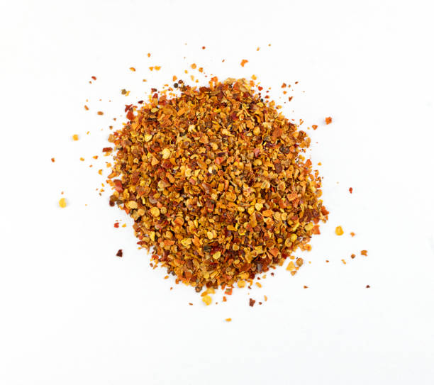 istock Pile of red pepper flakes isolated on a white background, top view 1308296495