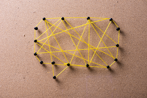 Message bubble made black pins and yellow string connecting  them.