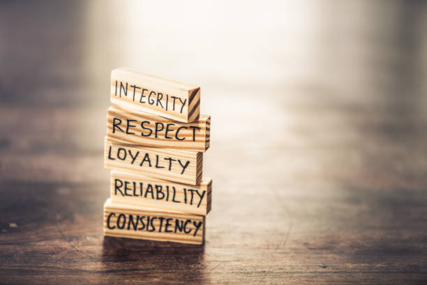 Integrity concept Businessman staking wood blocks with words hand written on them.  He is explaining the integrity values. morality stock pictures, royalty-free photos & images