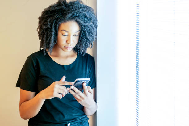 istock Woman in the office beside a window 1308297711