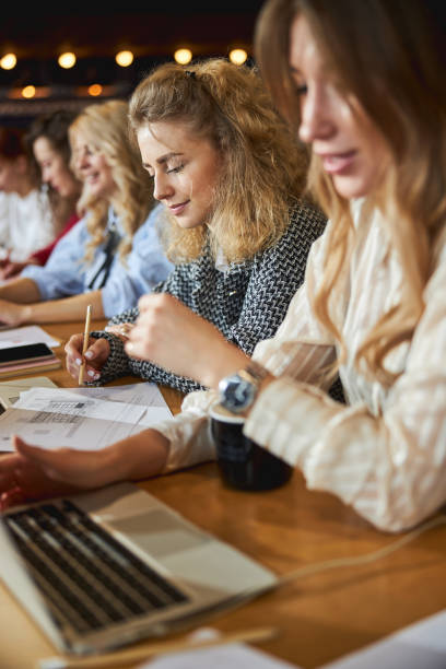 istock Charming young woman working on business project with colleagues 1308298993