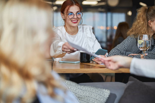 istock Charming young woman working on business project with colleagues 1308299081