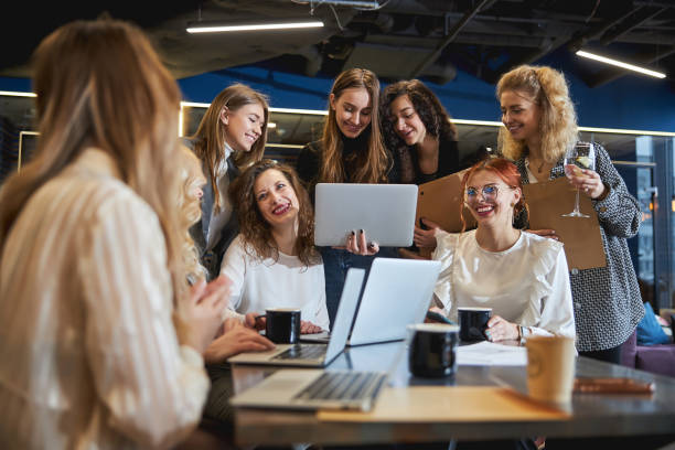 istock Cheerful young women working on business project in office 1308299097