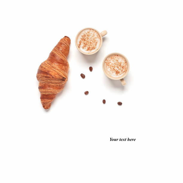 Cups of coffee and fresh croissant isolated on white background. Breakfast concept. Creative layout. Top view, copy space