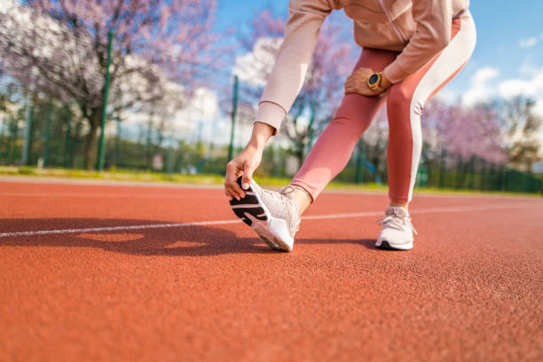 istock Sporty young woman warming up on running track. 1308301812
