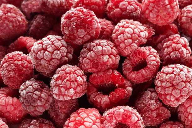 istock Frozen raspberries covered with hoarfrost. Berries background. 1308303078