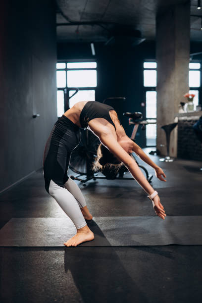 istock Slim athletic woman doing exercise bridge at gym 1308303873