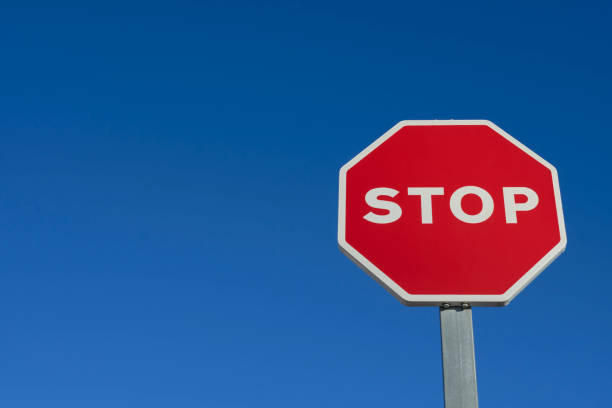 istock Stop traffic sign on blue background 1308303969
