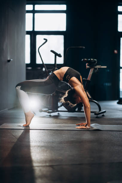 istock Slim athletic woman doing exercise bridge at gym 1308304615