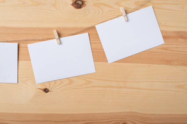 istock Empty white paper cards attached to the rope with clothespins 1308304790