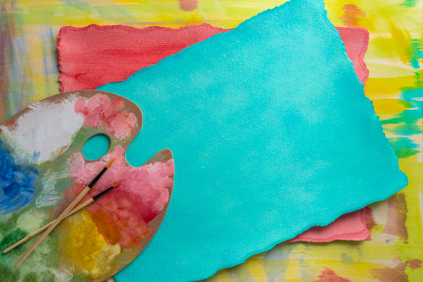 Abstract hand painted in vivid colors and copy space paper with painter artist palette and brushes