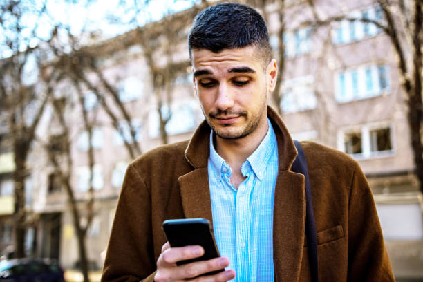 istock Young businessman using his smartphone on the street 1308307201