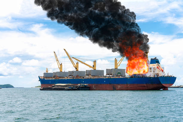 istock Large general cargo ship for logistic import export goods and other the explosion and had a lot of fire and smoke at sea in bright day 1308308745