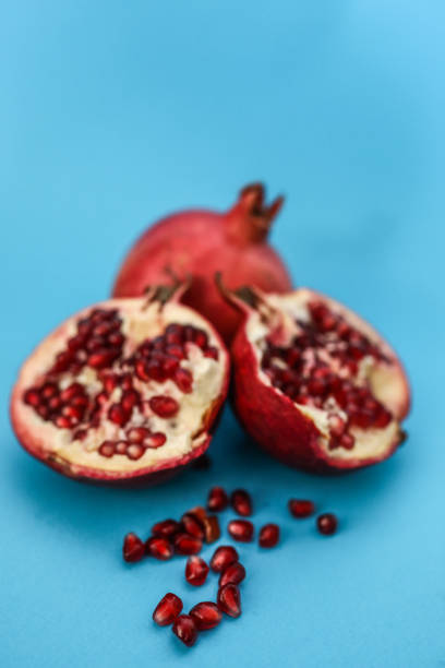 istock Pomegranates And Their Seeds On A Blue Background 1308309559