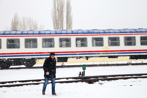 Unknown people walking in the train station on a cold winter day,Kars,Turkey. 24 January 2016
