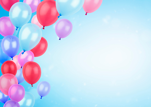 bright helium balloons on blue background with copy space