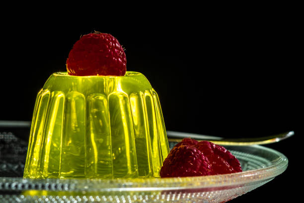 istock Lemon jelly dessert with raspberries on a glass plate 1308309927