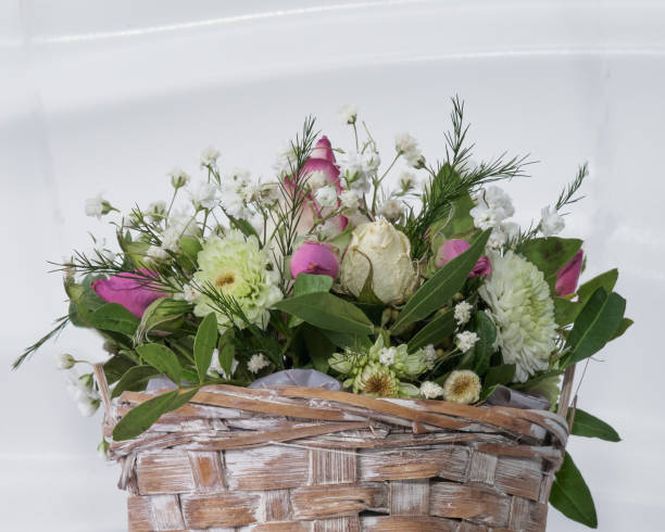 istock live beautiful flowers in a basket on a light background 1308311298
