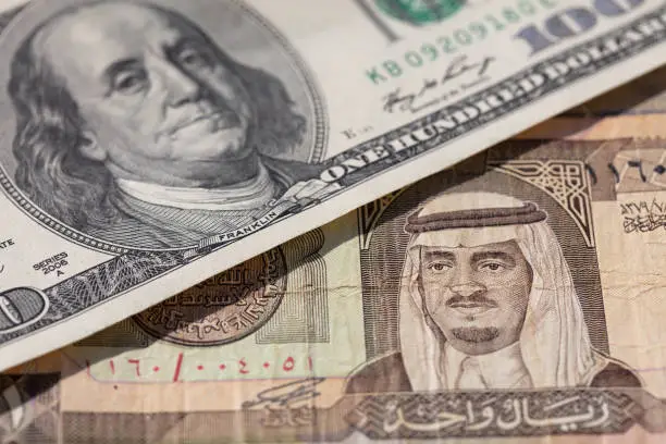 old one riyal of Saudi Arabia and 100 US dollar banknotes for design purpose