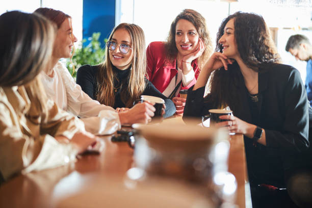 istock Cheerful female colleagues chatting during coffee break at work 1308315175