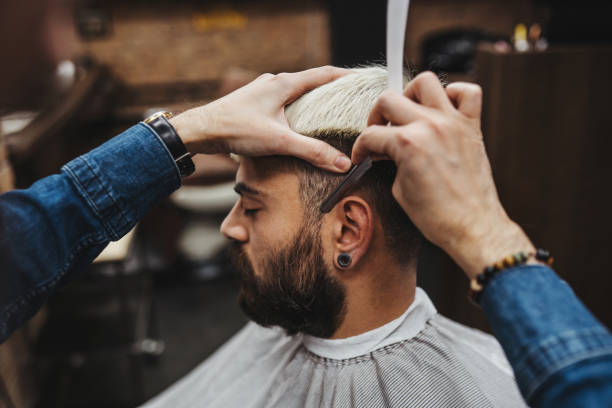 istock Barber cleaning his clipper - close up 1308315355