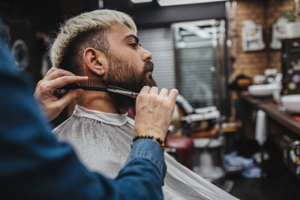 istock Barber giving a shaving in his shop 1308315931