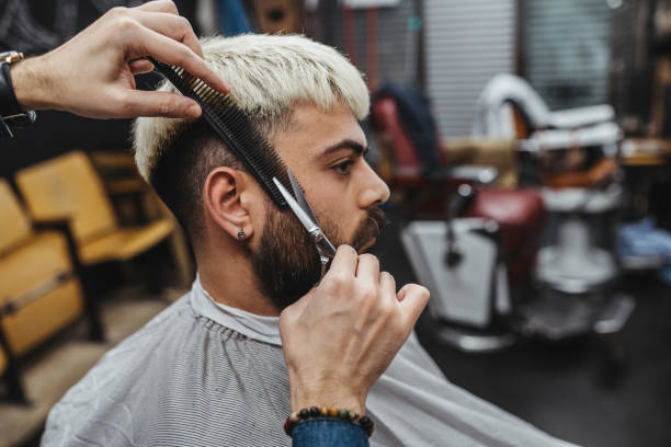 istock Barber giving a shaving in his shop 1308316036