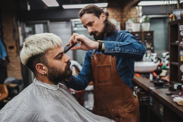 Barber giving a shaving in his shop