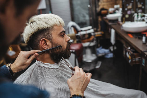 istock Barber giving a shaving in his shop 1308316067