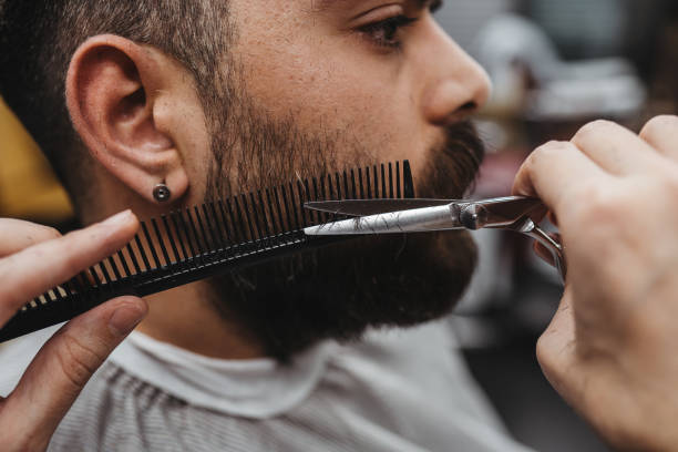 istock Barber giving a shaving in his shop 1308316068