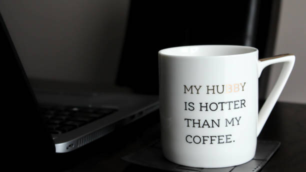 istock White cup with inspirational words next to laptop 1308316347