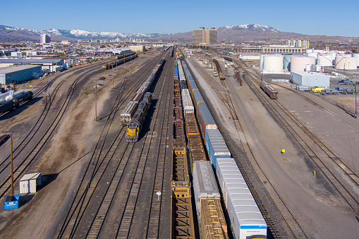 Sparks, Nevada USA - March 21, 2021: Aerial view of the Sparks, Nevada industrial area facing west, with Rail and truck transportation, warehousing a petroleum tank farm as well as hotels and casinos.