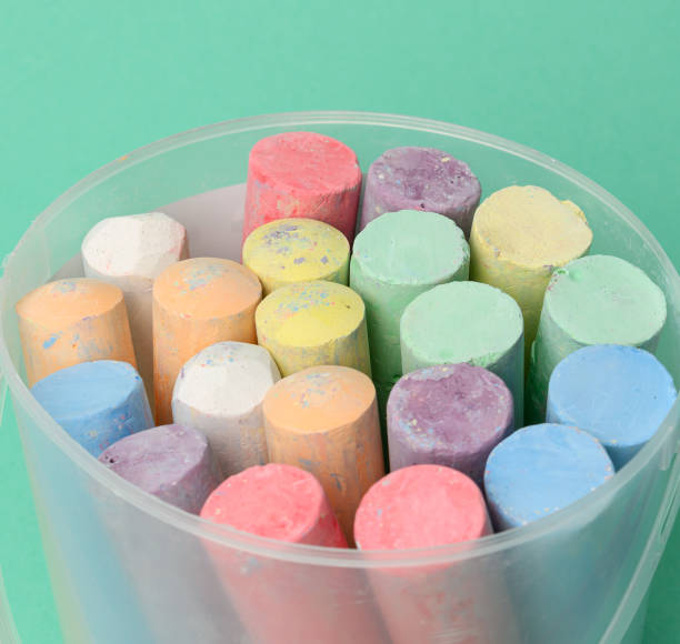 istock multicolored chalk in a plastic bucket on a green background, 1308317534